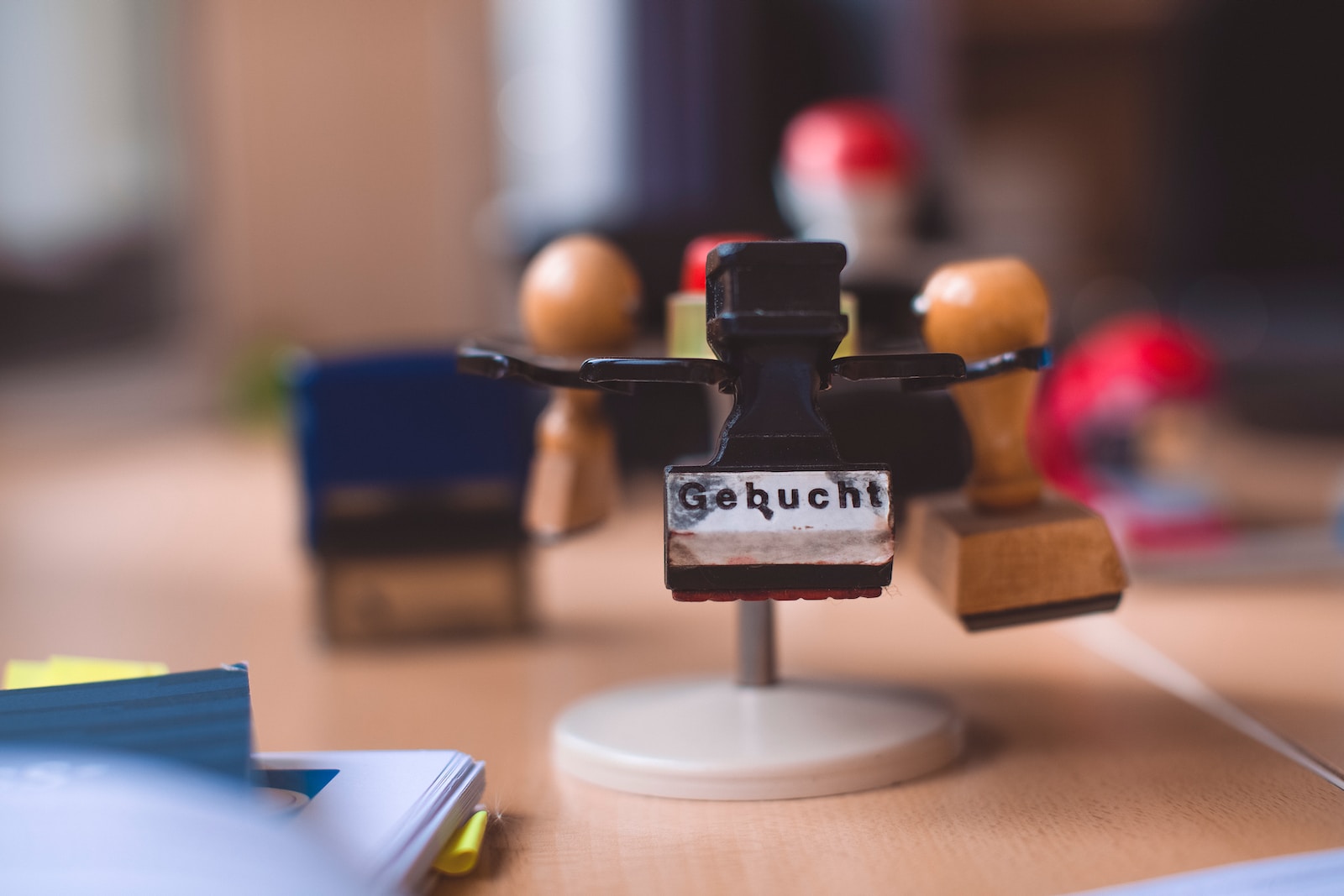 a group of wooden people standing on top of a wooden table