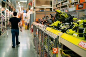 a man is walking down a store aisle